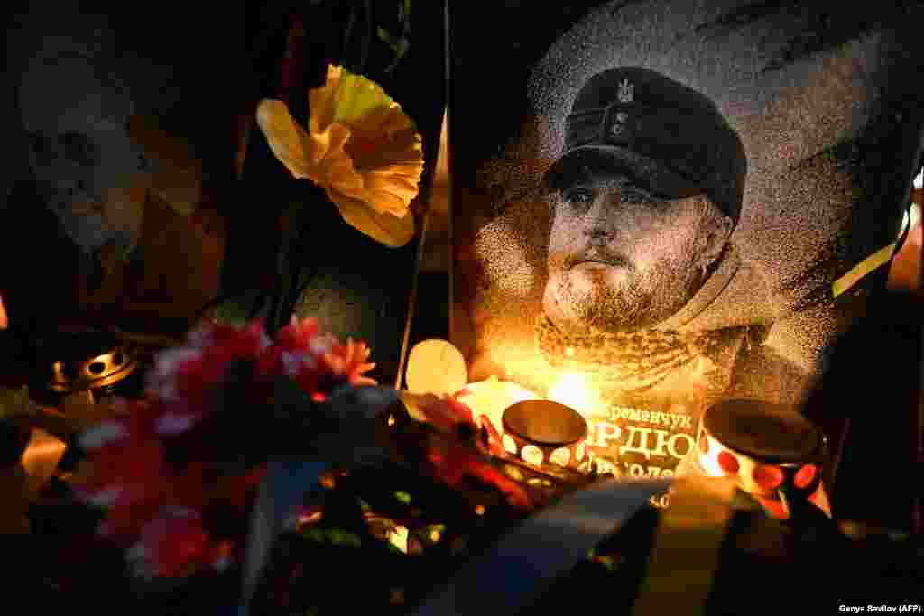 Flowers and candles adorn a memorial for slain Maidan activists on the sixth anniversary of the start of the pro-Western protests in central Kyiv on November 21. (AFP/Genya Savilov)