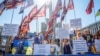 Relatives of missing Ukrainian soldiers hold flags and signs while attending a rally as the country celebrates Independence Day in Kyiv on August 24.