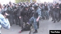 A YouTube video shows a Russian OMON officer kicking a woman in the abdomen during May 6 antigovernment protests.