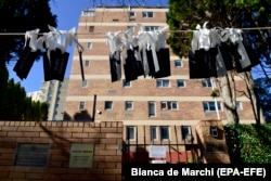 Tags with the names of all 298 passengers who lost their lives on board MH17 are seen hanging between trees in front of the Russian Consulate-General building in Sydney on July 17.