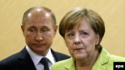 According to the Kremlin Russian President Vladimir Putin (left) spoke to German Chancellor Angela Merkel by telephone "at the initiative of the German side.” (file photo)