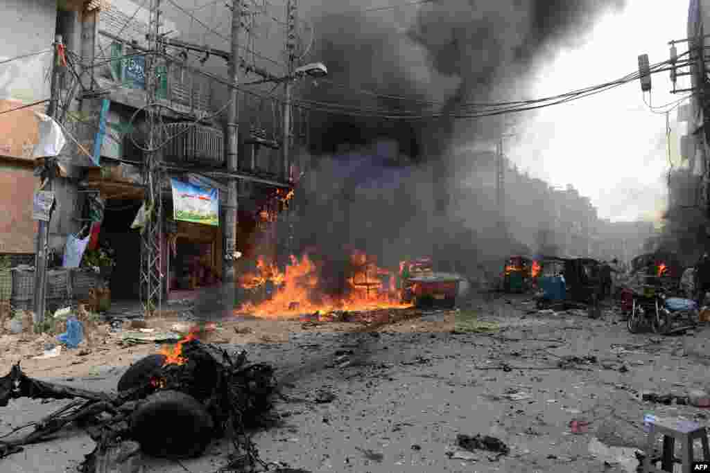 The blasts set shops and cars ablaze along the narrow market corridor. One eyewitness said he watched helplessly as a group of women and children burned to death in their car. 