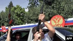 South Ossetian men shoot in the air to celebrate the recognition of South Ossetian independence by Russia in August 2008.