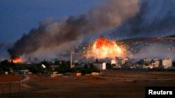 Smoke and flames rise over the Syrian town of Kobani after an air strike by a U.S.-led coalition on October 20.