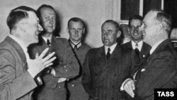 German Foreign Minister Joachim von Ribbentrop (right) talks with Adolf Hitler (left) on his arrival to Berlin after signing the 1939 Molotov-Ribbentrop Pact.