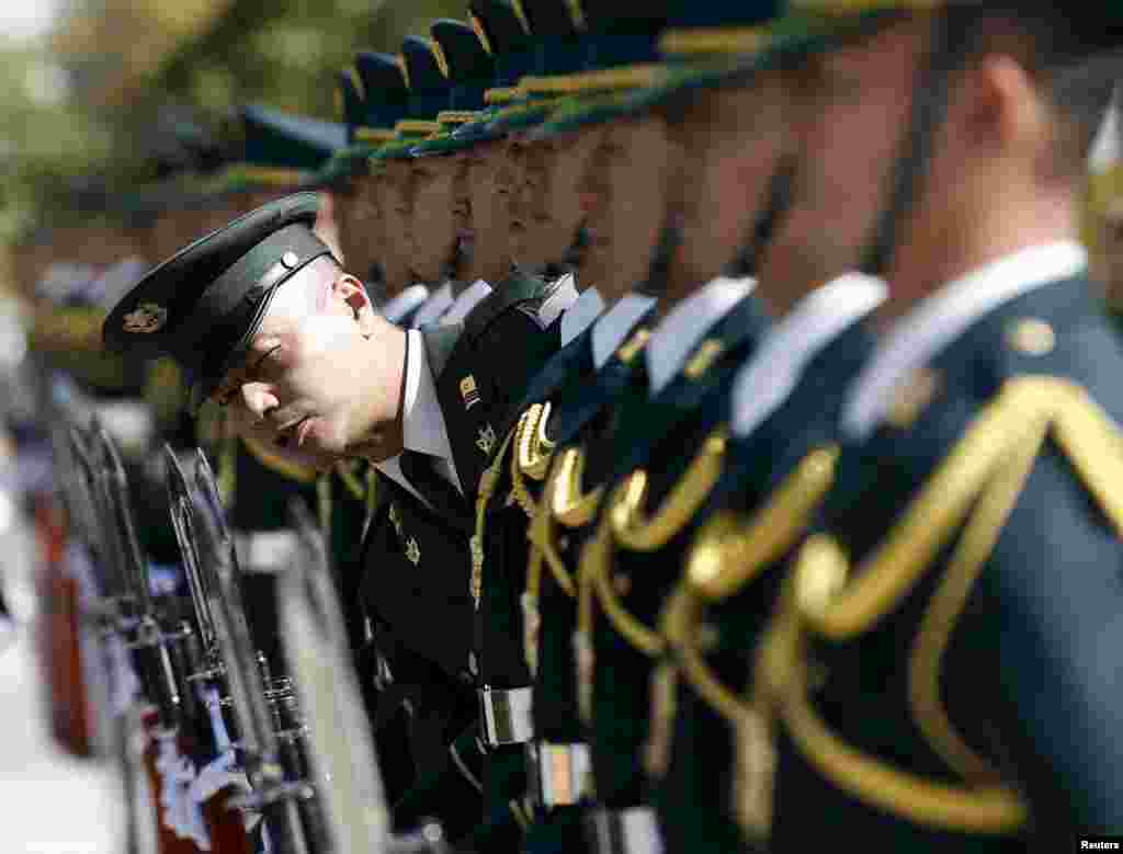 Members of Japan's Self-Defense Force's honor guard prepare for a ceremony for U.S. Army General Martin Dempsey, chairman of the Joint Chiefs of Staff, at the Defense Ministry in Tokyo. (Reuters/Toru Hanai)