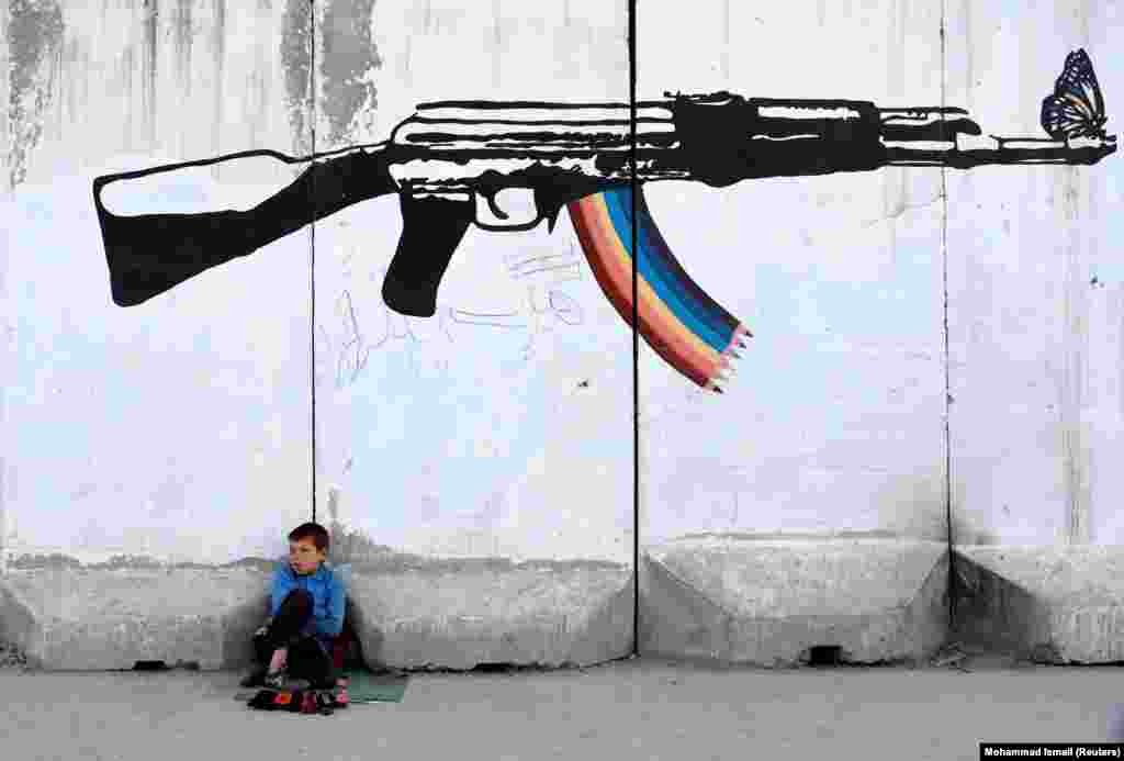 A shoe polisher waits for customers in Kabul. (Reuters/Mohammad Ismail)