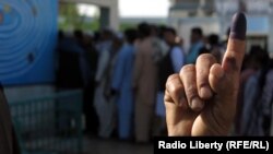 A voter shows off his finger after voting in the southern Afghan city of Kandahar.