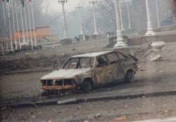 A bombed out car near Dudayev's makeshift presidential palace
