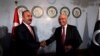 Turkish Foreign Minister Mevlut Cavusoglu (L) shakes hands with Adviser to Pakistan's Prime Minister on National Security and Foreign Affairs, Sartaj Aziz in Islamabad on August 2.