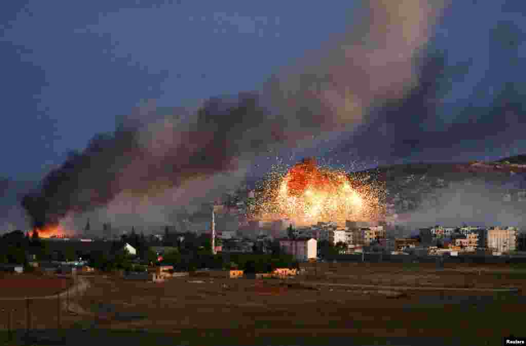 Smoke and flames rise over the Syrian town of Kobani after an air strike against Islamic State militants by a U.S.-led coalition. (Reuters/Kai Pfaffenbach)