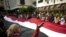 Antigovernment protesters hold a giant Egyptian flag as they shout slogans against President Mubarak outside parliament.