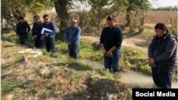 Local officials and farmers in the Tashkent region were forced to stand in a water-filled ditch.