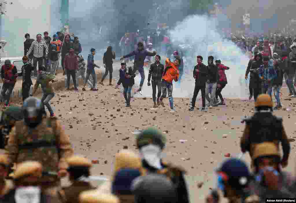 Demonstrators throw stone in Seelampur on December 17.