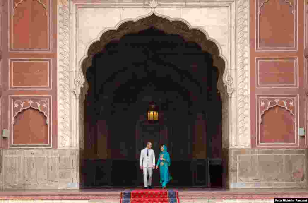 The royal couple in an archway of the Badshani Mosque in Lahore on October 17.