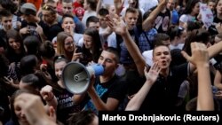 Primary school students shout slogans during a protest in Belgrade on June 19.