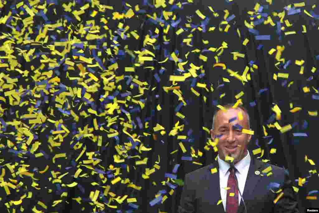 Ramush Haradinaj, a candidate for Kosovo prime minister, smiles behind falling confetti as he campaigns in Ferizaj. (Reuters/Hazir Reka)