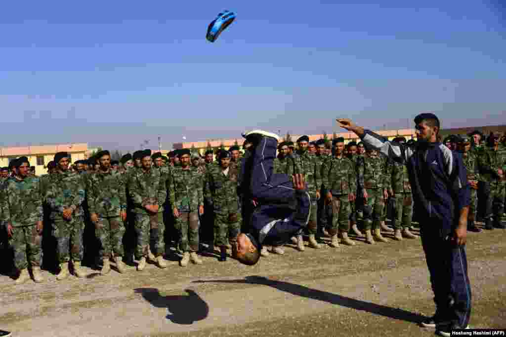 Një ushtar afgan tregon aftësitë e tij gjatë ceremonisë së diplomimit të mbajtur në bazën ushtarake në Guzara në provincën Herat.(AFP/Hoshang Hashimi)