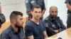 Russian citizen Aleksei Burkov (center) attends a court hearing in Jerusalem on November 3.