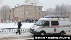 A vehicle from the Russian Emergencies Ministry is parked near the school in Perm after reports of a serious knife fight.