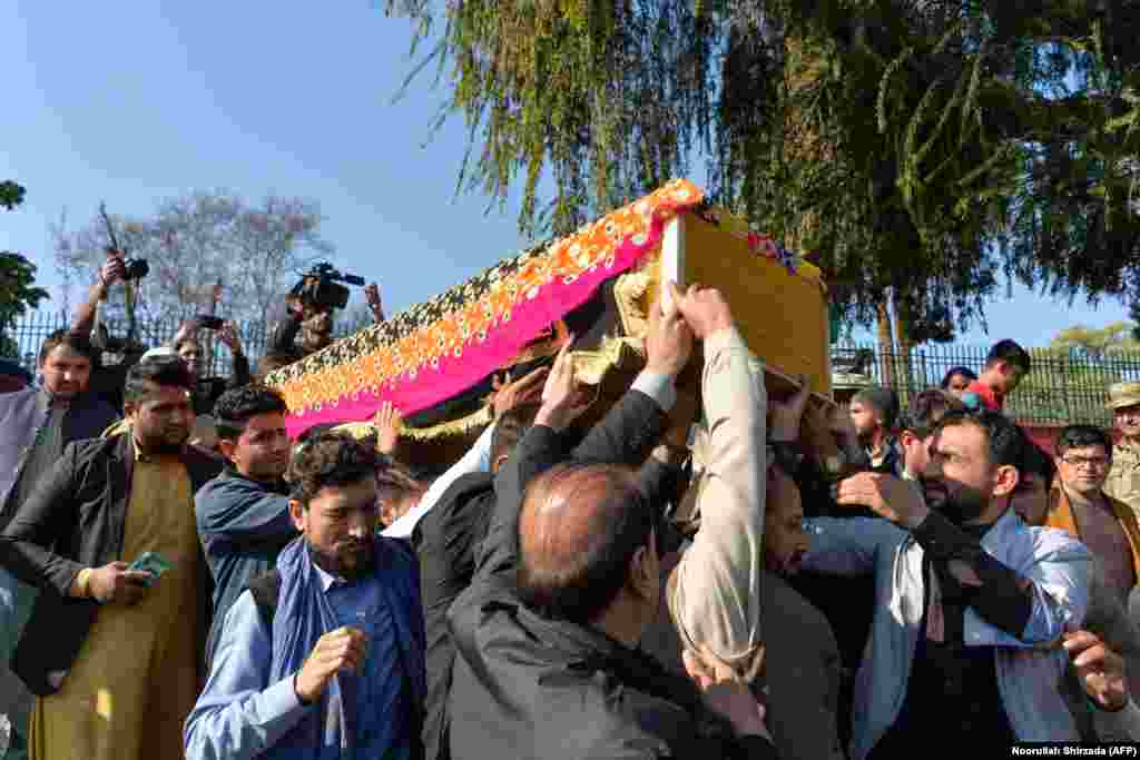 Mourners on December 10 carry the coffin of Afghan female news anchor Malalai Maiwand, who was shot dead by gunmen in Jalalabad. (AFP/Noorullah Shirzada)