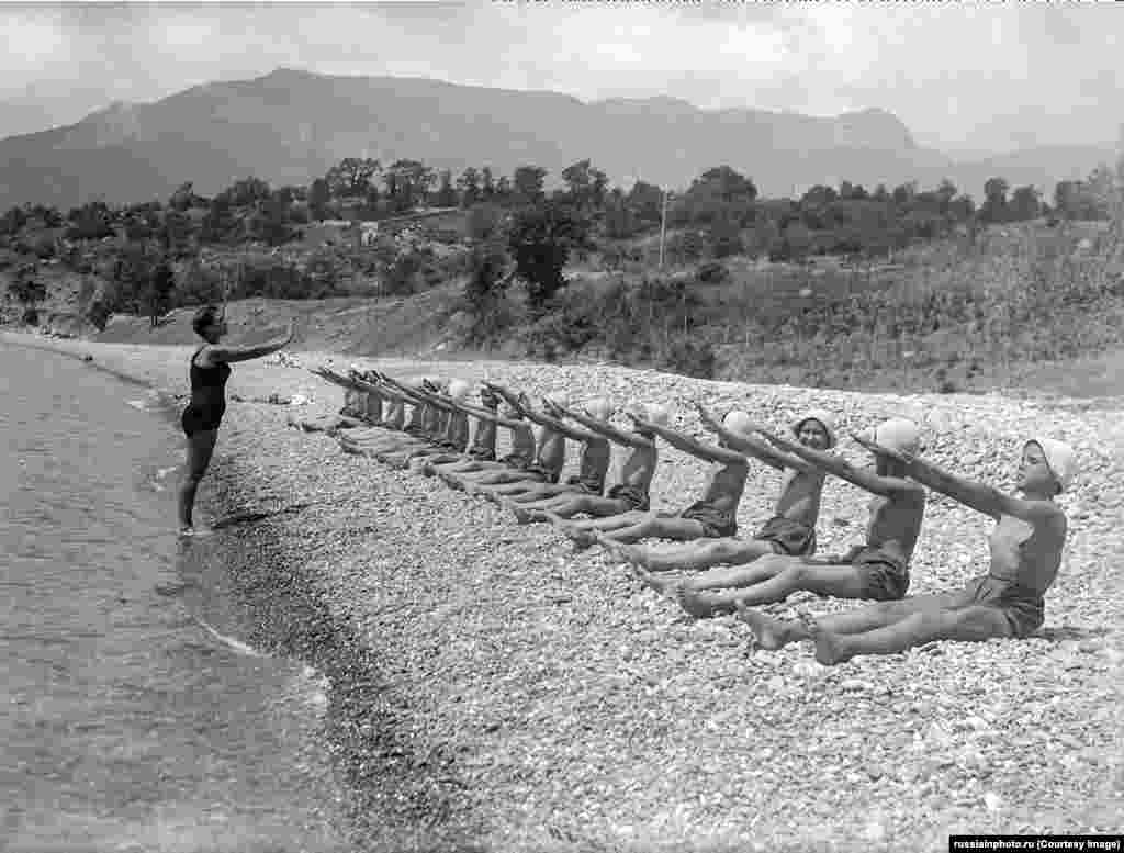Exercises on a pebbled beach at Artek in the 1930s.The camp soon expanded to become a feature of the Soviet Union’s communist youth organization, the Young Pioneers. Places at Artek were set aside each summer for high-performing children, as well as for the offspring of well-connected communist party members.
