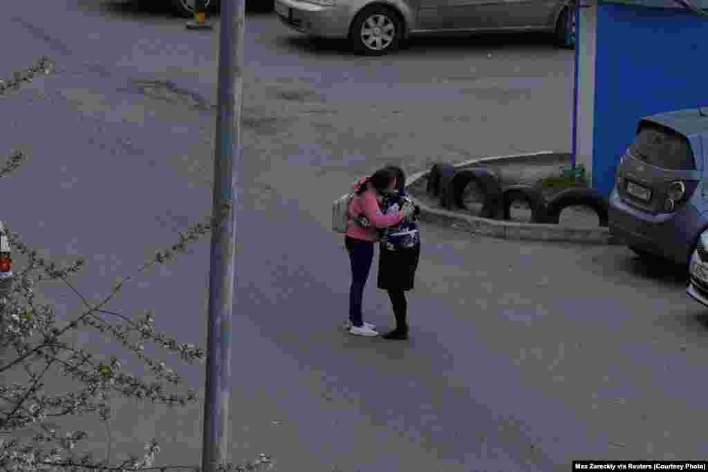 A parent embraces her child after the shooting.