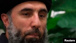 FILE: Gulbuddin Hekmatyar speaks to a Reuters correspondent in Tehran, February 2002.