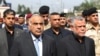 Iraq's Prime Minister Adel Abdel Mahdi (L) and Hadi al-Ameri, leader of the mostly Shiite Hashed al-Shaabi paramilitary units, attend a symbolic funeral ceremony in Baghdad on October 23, 2019 (Photo by AHMAD AL-RUBAYE / AFP)