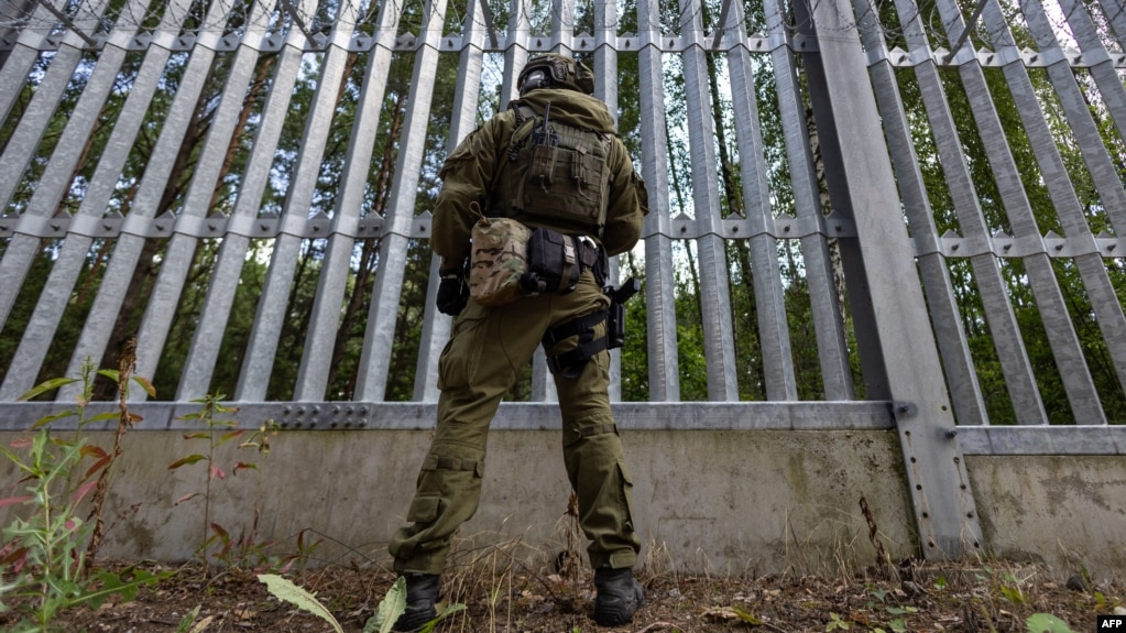 Польский пограничник на польско-белорусской границе перед ограждением. Пункт Половце-Пещатке, Польша, 21 июля 2025 года