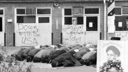 Iranian students pray inside the American Embassy compound before anti-American slogans on the third day of the occupation of the embassy in Tehran, Iran on Nov. 6, 1979. Sixty people are still held hostage against the deportation of the former Shah of Ir