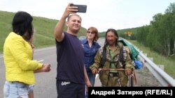 Aleksandr Gabyshev (with beard) attracted attention when he announced in 2019 that he would trek across Russia to exorcise Vladimir Putin from power.