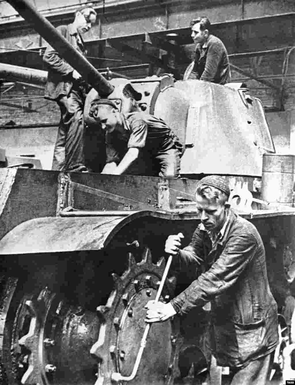 Workers assemble a T-34 tank in a workshop of the Kirov tank-manufacturing plant in Chelyabinsk, U.S.S.R., 1943.