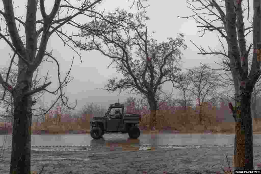 A Ukrainian soldier drives a vehicle on a road leading to the town of Chasiv Yar, Kostyantynivka, eastern Donetsk region.