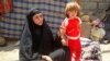 Iraq - An old woman with a kid in one of impoverished neighbourhoods in Kut, Kut, 18Aug2012