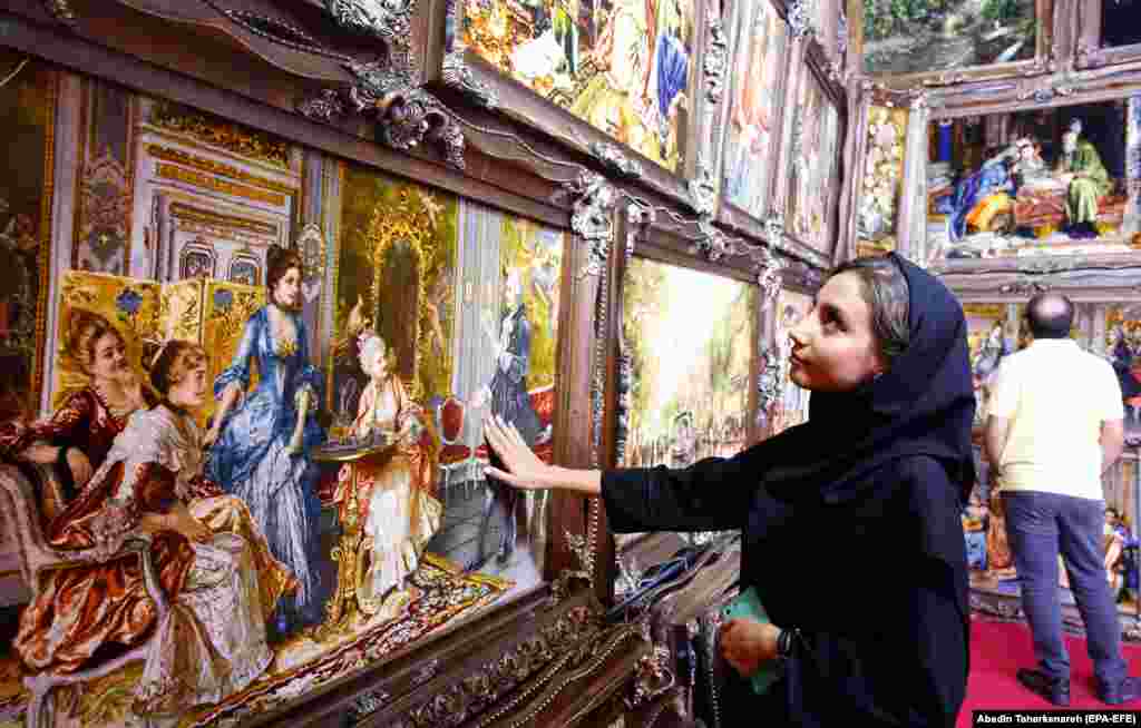 An Iranian woman visits a handmade carpet exhibition in Tehran. (epa-EFE/Abedin Taherkenareh)