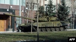 Pro-Russian separatists ride on a tank in the eastern Ukrainian city of Donetsk on February 15.