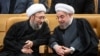 Iran's head of judiciary, Ayatollah Amoli-Larijani (L) speaking with president Hassan Rouhani. File photo