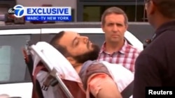 U.S. - Ahmad Khan Rahami being loaded into an ambulance after a shoot-out with police in Linden, New Jersey, U.S., September 19, 2016