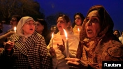 Members of civil society hold candle vigil for the victims of Peshawar school attack in Islamabad on December 22.