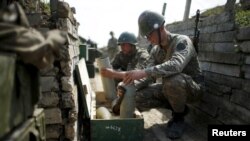 Nagorno-Karabakh -- Ethnic Armenian soldiers check cannon's shells in a trench at artillery positions near the Nagorno-Karabakh's town of Martuni, April 7, 2016