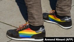 KOSOVO -- A man marches with shoes bearing the pride flag, during the country's first Gay Pride parade in Pristina, October 10, 2017