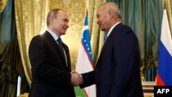 Russian President Vladimir Putin (left) meets with Uzbek President Islam Karimov at the Kremlin in Moscow on April 26.