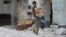 A boy carries bread in the Syrian city of Latamneh, which was reportedly hit two days ago by Russian air strikes. 