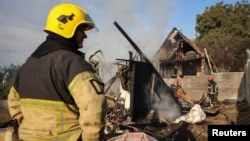 Firefighters work at the site of the Russian missile strike in the village of Sknyliv on the outskirts of Lviv, Ukraine, on August 21.