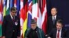 NATO Secretary-General Anders Fogh Rasmussen (right) and Afghan President Hamid Karzai sign a long-term security partnership in Lisbon on November 20. But will the partnership endure?