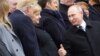 Russian President Vladimir Putin (right) greets German Chancellor Angela Merkel and U.S. President Donald Trump as they attend a commemoration ceremony for Armistice Day in Paris on November 11.