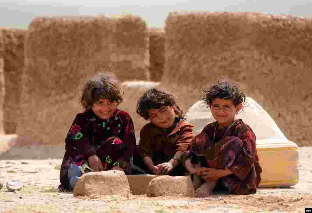 Afghan children pose for a photograph near their temporary shelter in Mazar-e Sharif. (epa/Sayed Mustafa)
