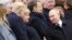 Russian President Vladimir Putin talks with German Chancellor Angela Merkel and U.S. President Donald Trump as they attend a commemoration ceremony for Armistice Day, 100 years after the end of the First World War at the Arc de Triomphe, in Pari