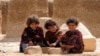 Afghan children pose for a photograph near their temporary shelter in Mazar-e Sharif, April 24, 2015